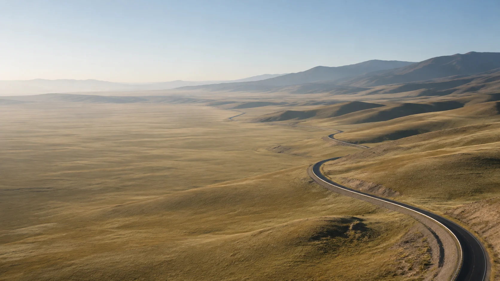 A winding road across a broad steppe landscape, a conceptual brand visual